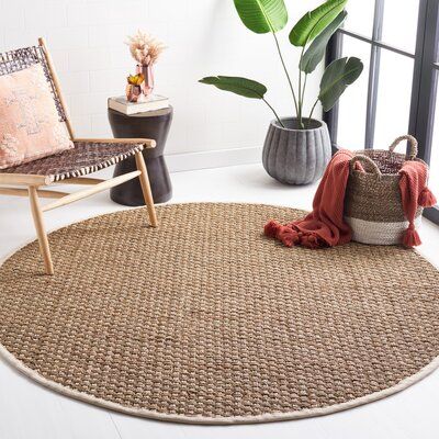 seagrass rugs in a round shape with beautiful chair and plant in a room