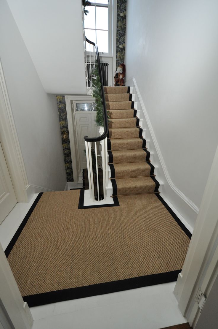 Sisal Carpet Runner in skin color with black border placed on beautiful stairs