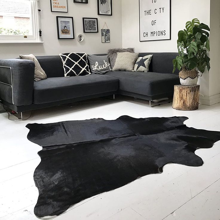 Cow hide rugs in black color look elegant in a room