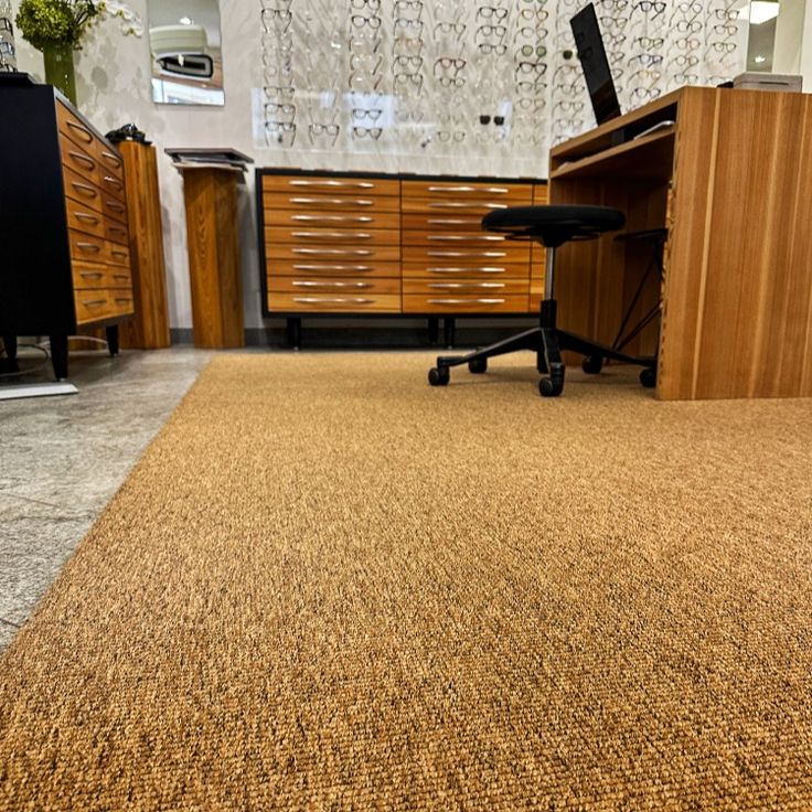 Commercial sisal carpet in golden color placed in office room
