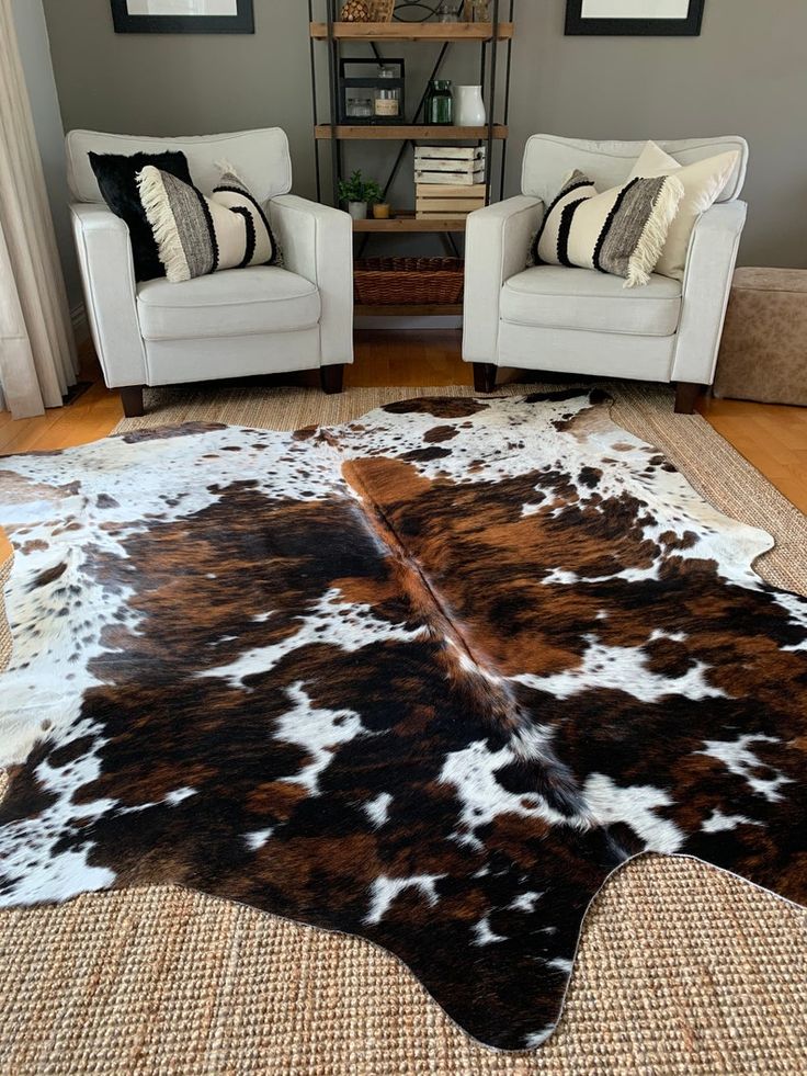 Cow hide rugs in a room with two beautiful sofas